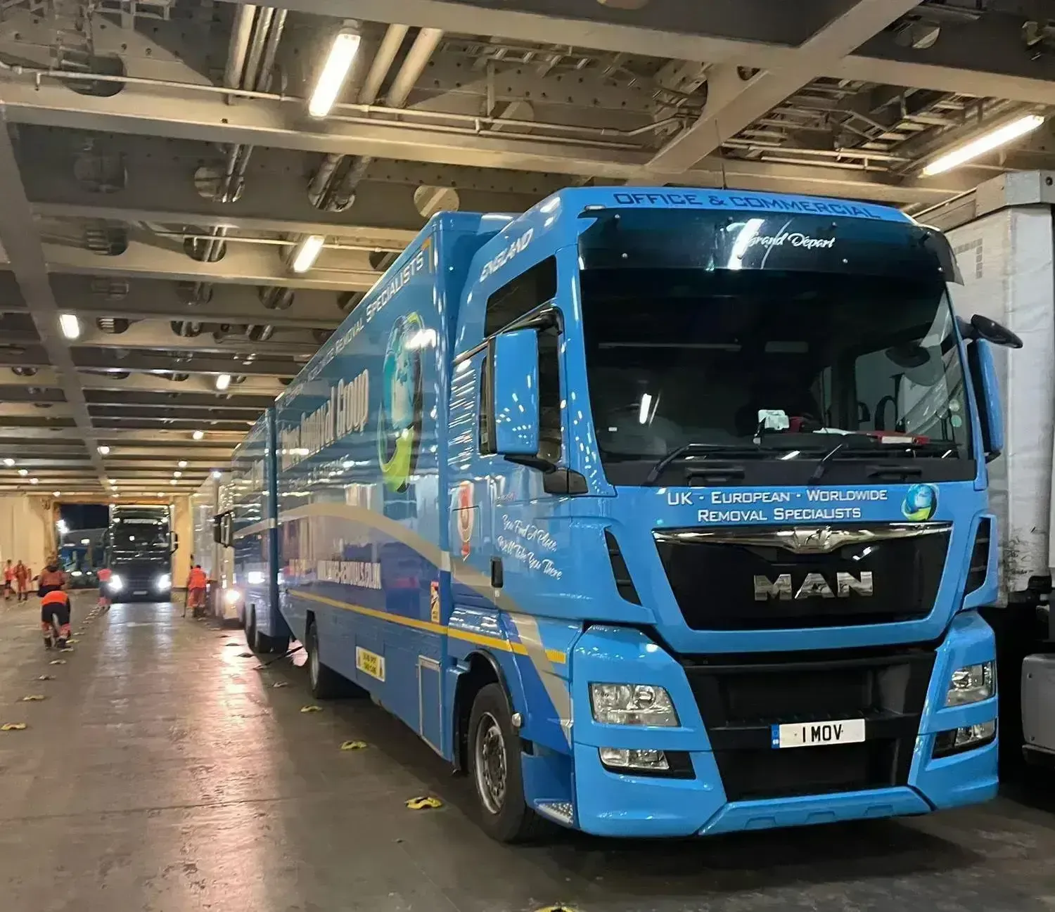 A big blue colour truck inside the storage unit for removals to Spain