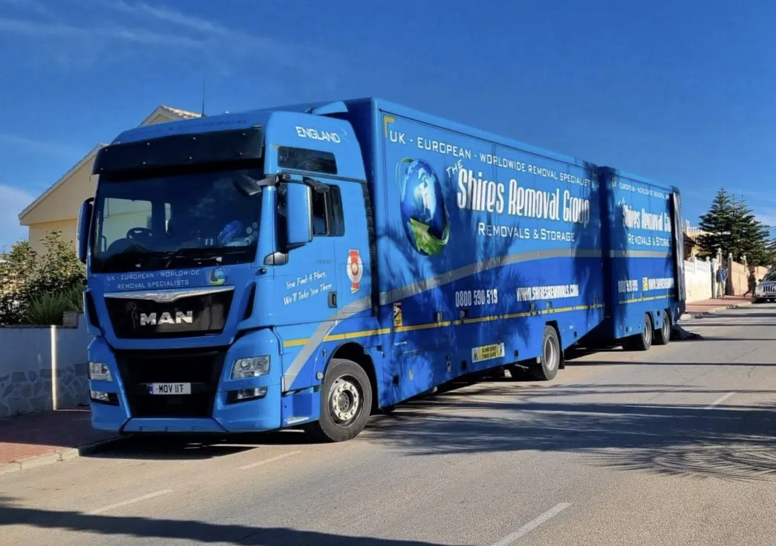 A big blue colour truck on the road for removals to spain